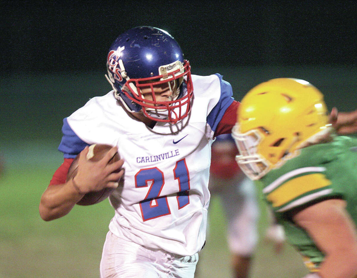 Carlinville’s Jacob Dixon (left) pushes his way past Southwestern defender Brett Schiller Friday night in Piasa. Dixon ran for 194 yards in his team’s 56-14 victory. The Cavies’ win, combined with Vandalia’s 32-7 win over Pana Friday leaves Carlinville, Vandalia and Pana tied atop the South Central Conference standings at 7-1.