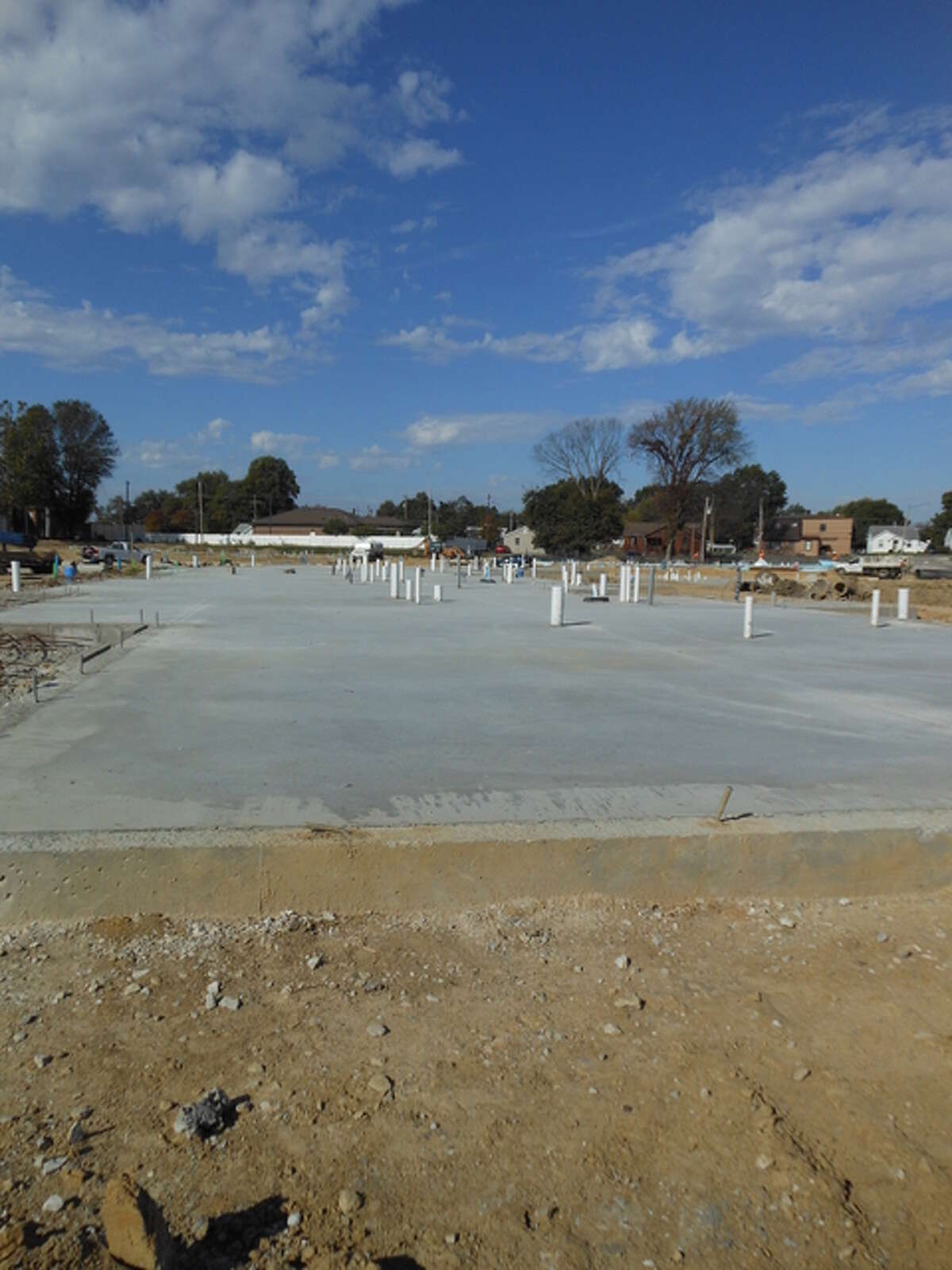 A concrete pad awaits construction workers from Morrissey Construction Co., of Godfrey, on which to build one of 13 apartment buildings at Madison County Housing Authority’s former Northgate complex, to be called Woodland Park apartments.