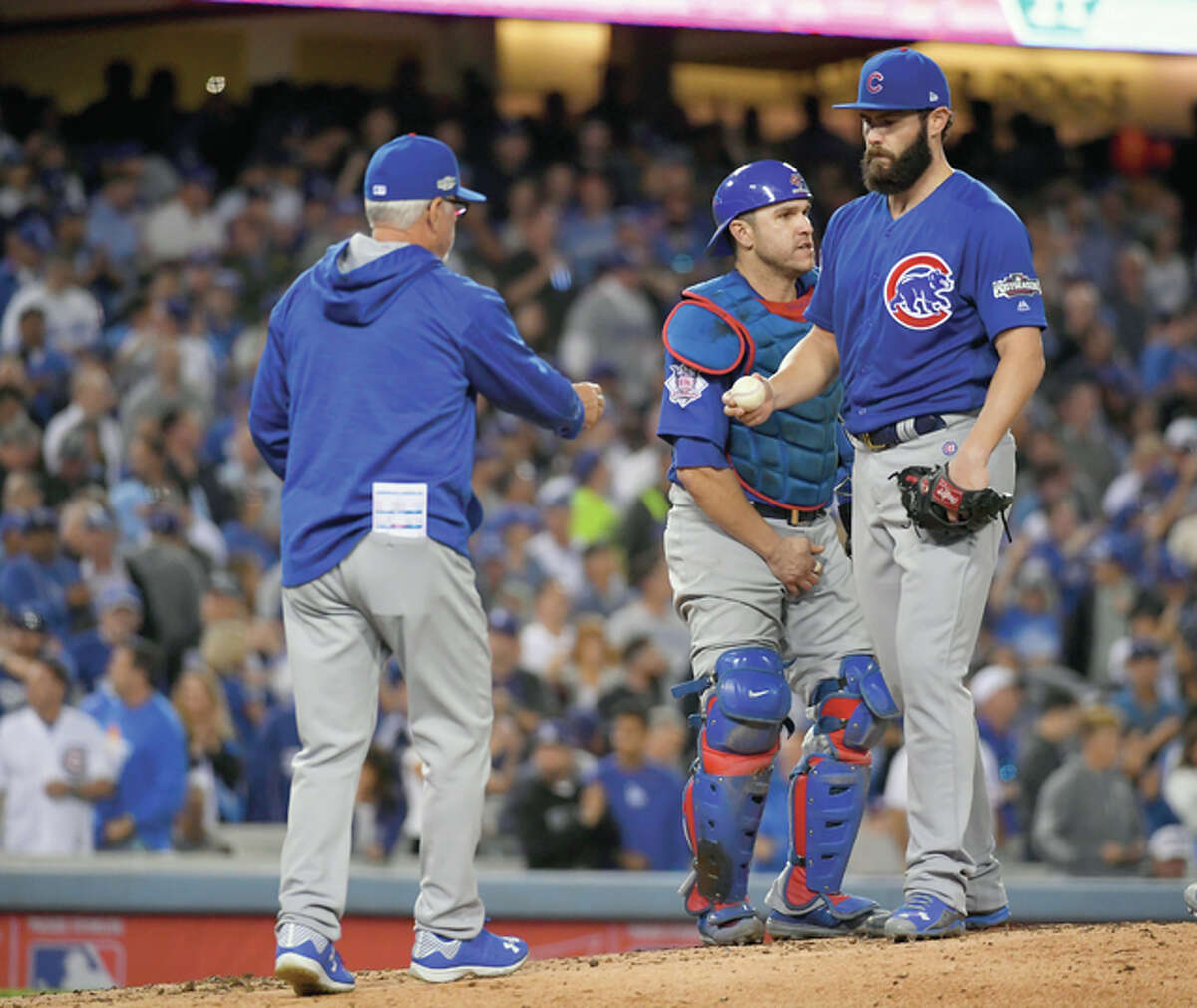Chicago Cubs manager Joe Maddon takes starter Jake Arrieta out of the game during the sixth inning of Game 3 of the National League Championship Series against the Dodgers Tuesday night in Los Angeles.