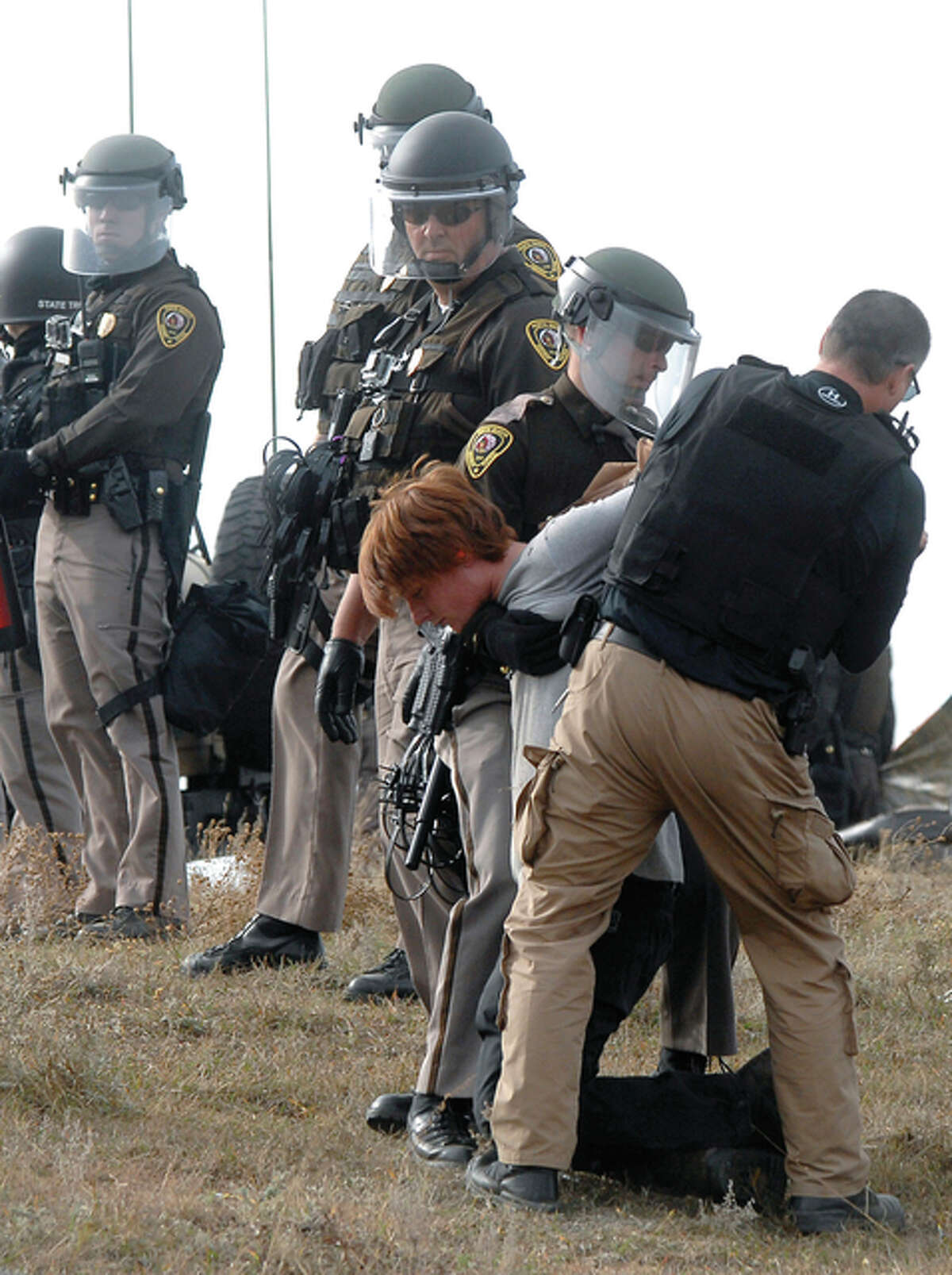 An unidentified Dakota Access Pipeline protester is arrested inside the Front Line Camp as law enforcement surround the camp to remove the protesters from the property and relocated to the overflow camp a few miles south of Highway 1806 in Morton County, North Dakota, Thursday, Oct. 27.