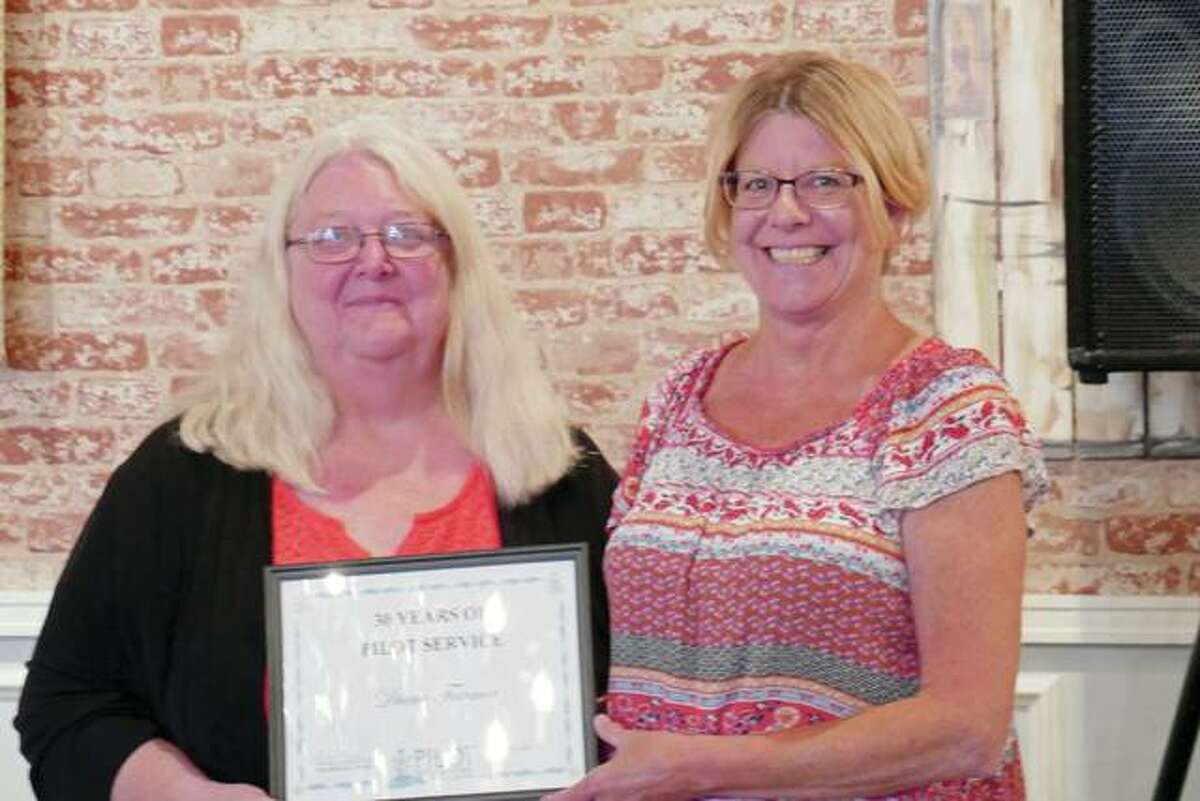 Pilot Club of Jacksonville 2016-17 President Patty Osborne (left) presents Diane Farmer with an award recognizing Farmer’s 30 years of service to Pilot Club.