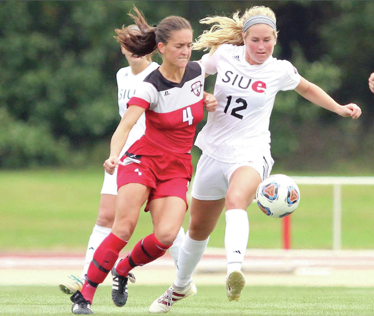 SIUE’s Lindsey Fencel (12) battles for the ball with Gina Fabbro of Austin Peay earlier this season. Fencel, a graduate of Civic Memorial High, scored the Cougars’ only goal in a 1-0 victory over Eastern Kentucky Sunday in the Ohio Valley Conference Tournament championship game. SIUE will play at No. 2 seed Notre Dame Friday in the NCAA Tournament.