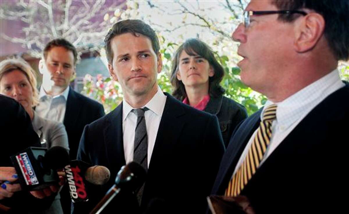 Former U.S. Rep. Aaron Schock, center, and members of his family listen as attorney Jeff Lang, right, speaks during a press conference Thursday, outside Peoria Heights Village Hall in Peoria Heights, Ill. Schocks defense team said Thursday that the former congressman, who resigned amid scrutiny of lavish spending, expects to be indicted by a federal grand jury.