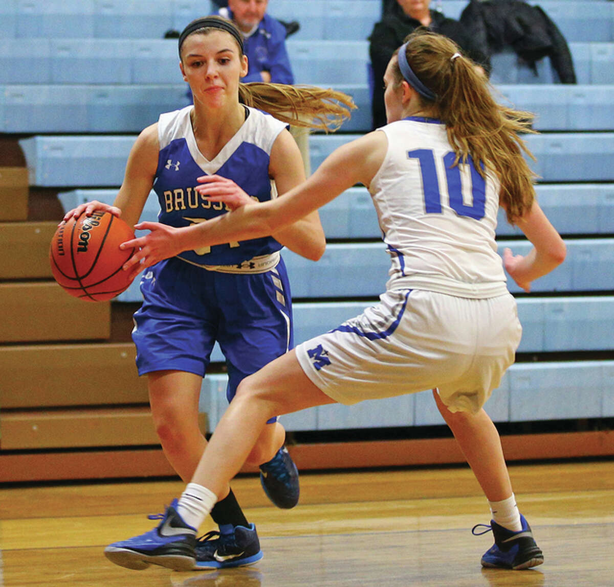 Brussels senior Baylee Kiel, sghown driving on Marquette Catholic’s Lila Snider in a game last season, scored 28 points in the Raiders’ victory at Southwestern on Thursday night.