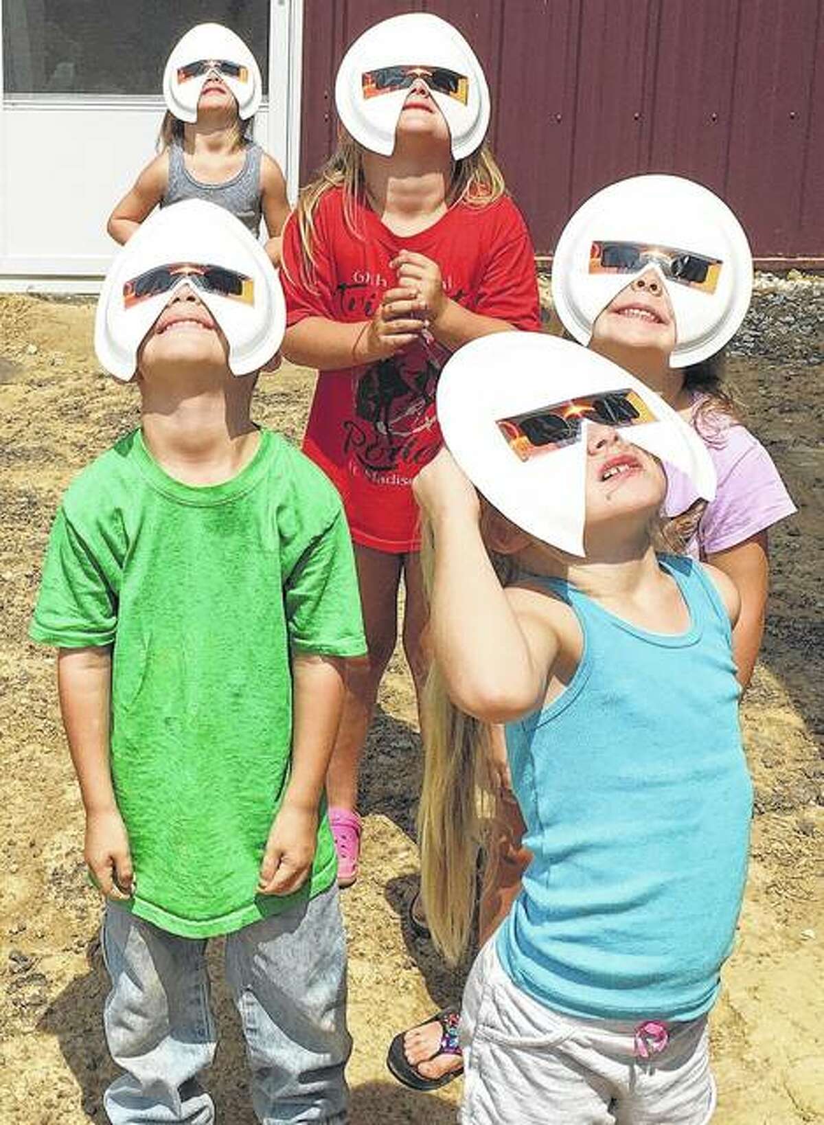 A group of 4- and 5-year-olds safely view the solar eclipse Monday near Waverly.