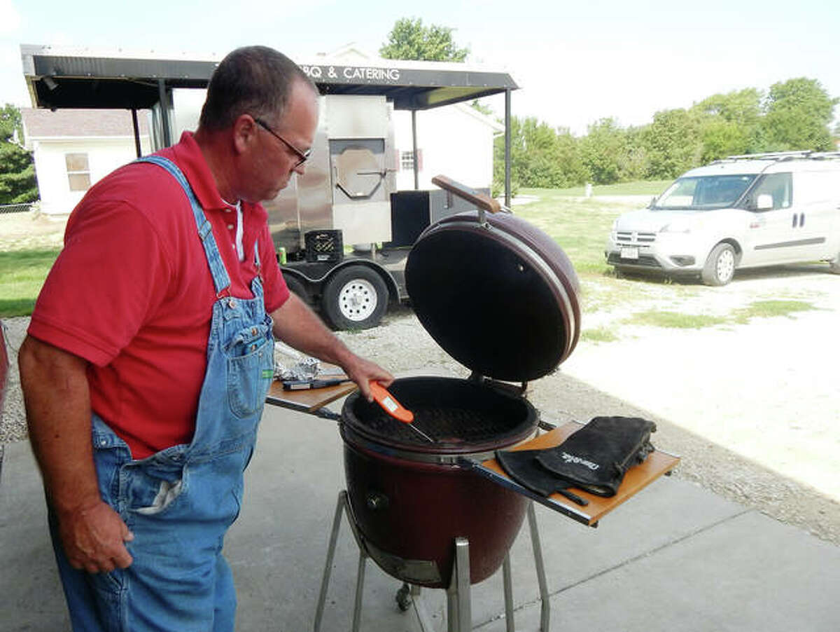 Randy Twyford of Twyford BBQ & Catering uses a digital thermometer Monday to check the temperature of a sirloin steak he’s grilling.