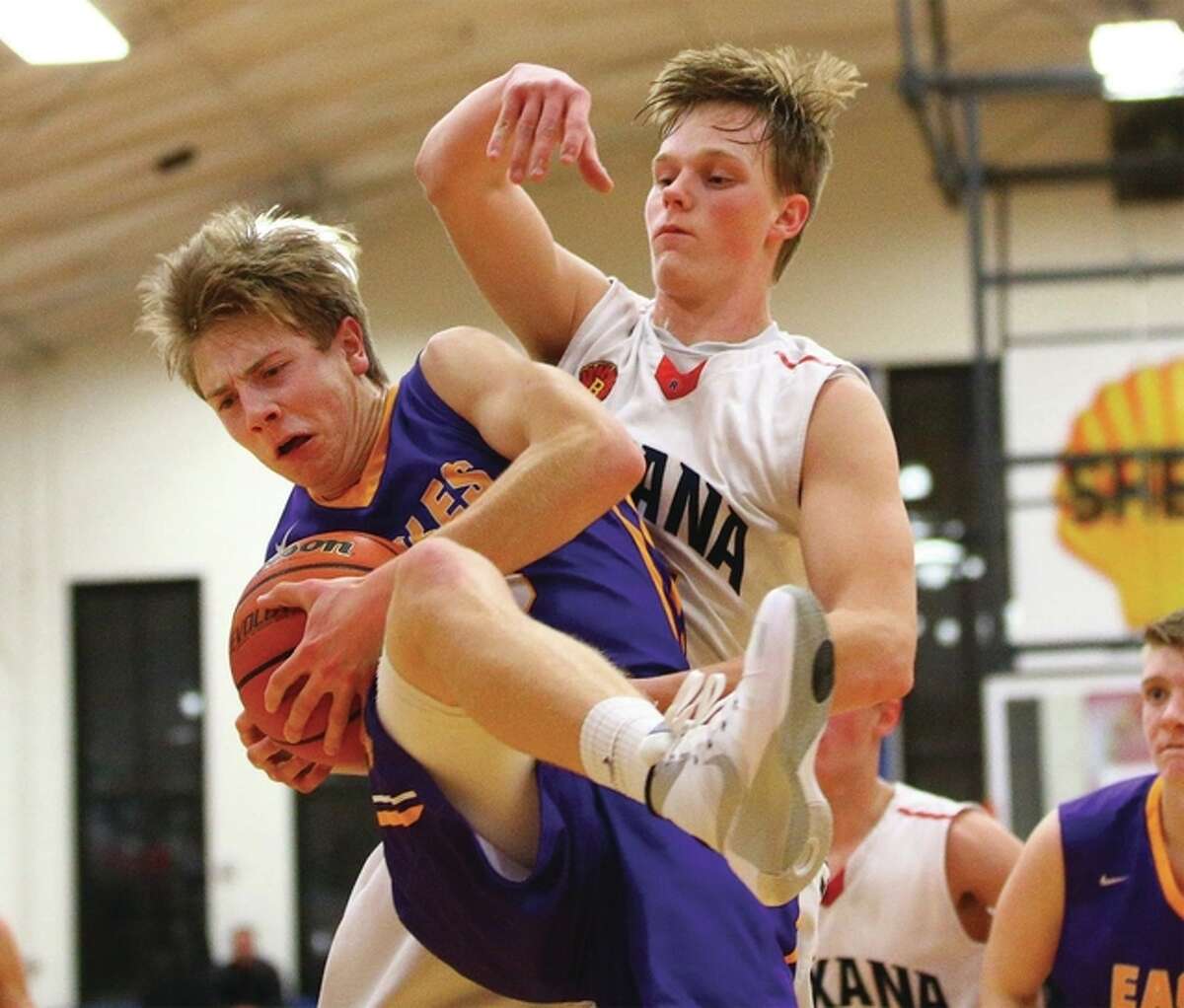 Civic Memorial’s David Lane (front) scored 13 points to help his team beat rival Roxana 65-32 Friday night in Bethalto. He is shown rebounding in front of Roxana’s Cody McMillen in action last season. McMillen scored 12 points for the Shells Friday.