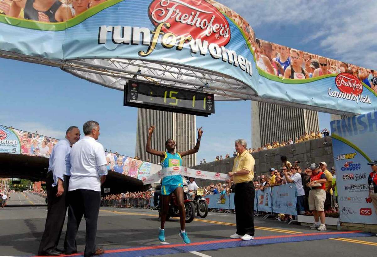 Emily Chebet of Kenya crosses the finish line to win the 32nd Freihofer's Run for Women June 5, 2010. (Michael P. Farrell / Times Union)