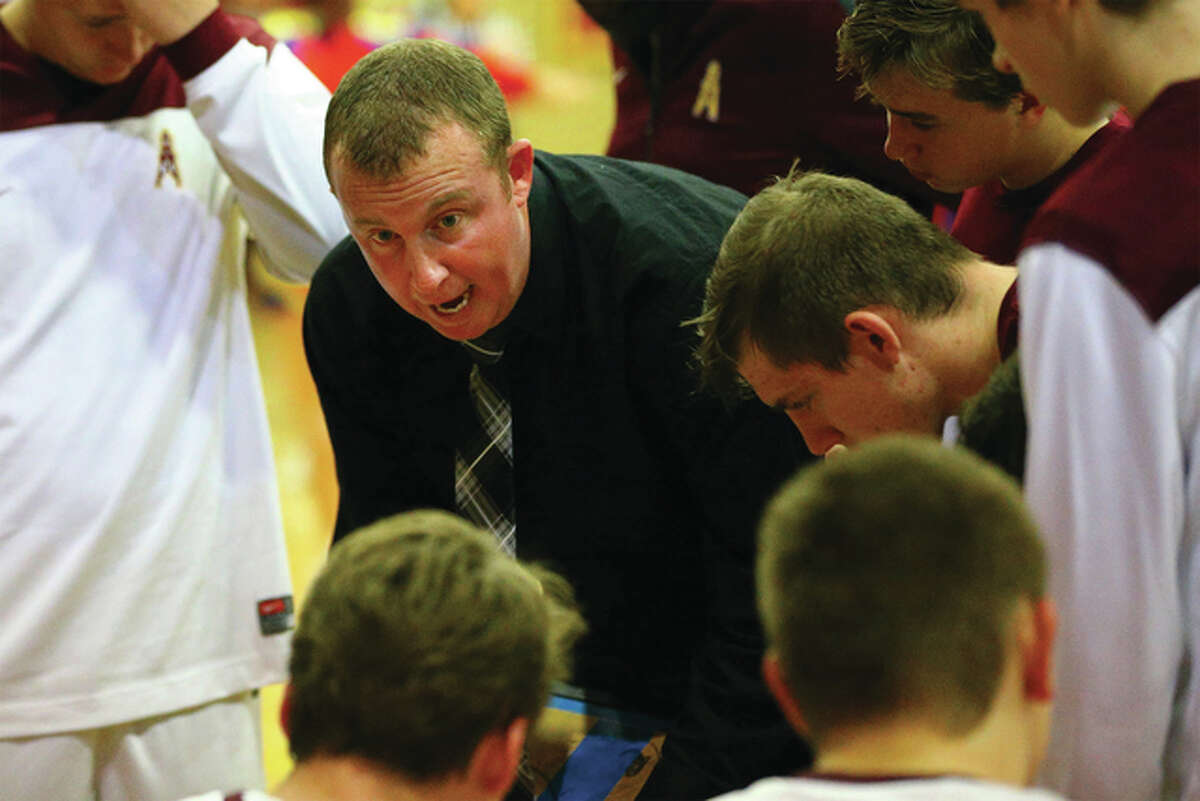 East Alton-Wood River coach Kyle Duncan talks to his players during a game last season at Memorial Coliseum in Wood River. The Oilers will spend some of their holiday week at Carlinville, where the Cavaliers’ annual boys and girls basketball tournaments tip off Monday. Other boys tourneys involving area teams start Monday at Freeburg and Waverly, Tuesday at Pinckneyville, Bloomington and Breese, and Wednesday at Collinsville and Centralia.