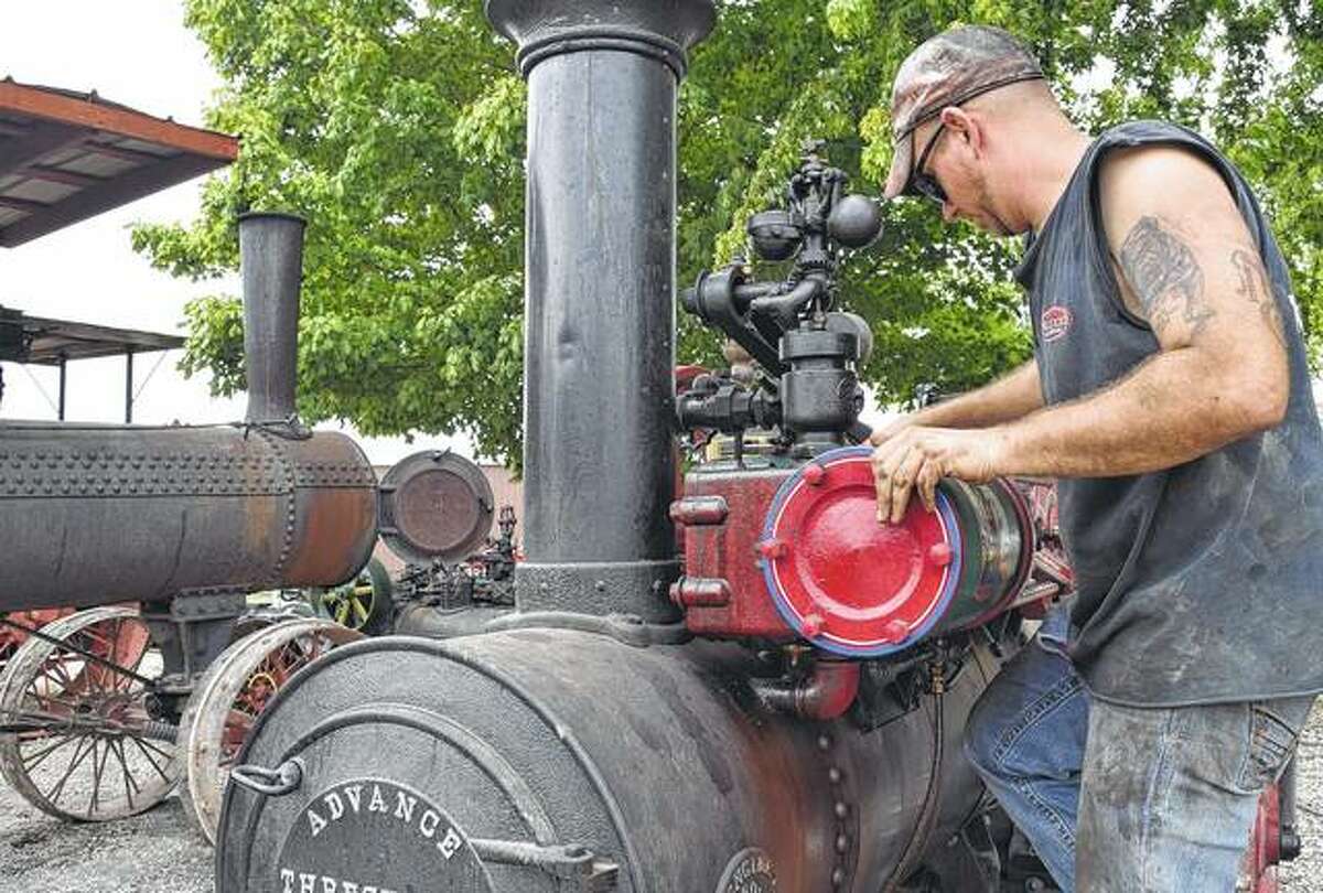 Matt Hall of Houghton, Iowa, inspects an 1892 Advance 6 horsepower steam traction engine Thursday prior to this weekend’s annual Prairie Land Heritage Museum Fall Festival and Steam Show Days, which begin today in South Jacksonville. The Advance engine, which will be running this weekend, is one of only three of its type known to exist, according to Hall.