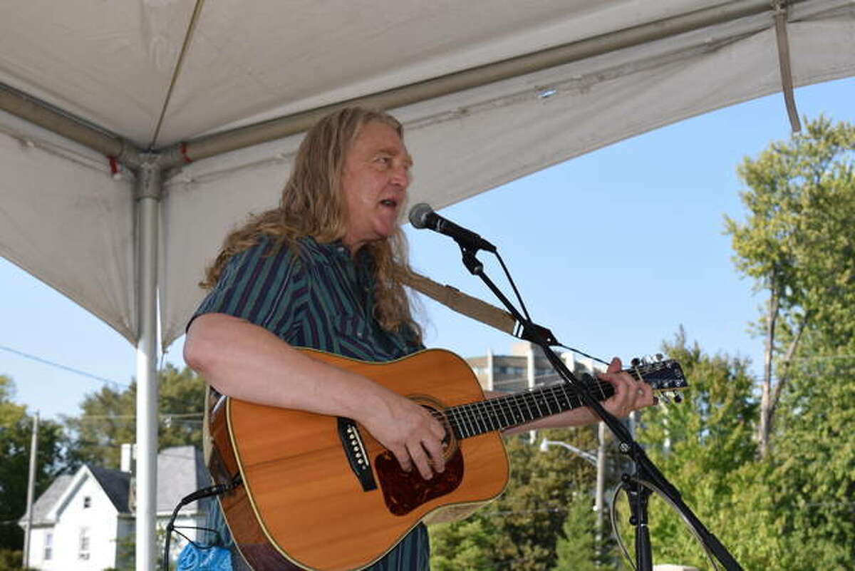 Singer and songwriter Tom Irwin of Springfield performs Saturday at the Jacksonville Public Library’s second annual Bookstock, a Backyard Roots Music Festival, just south of the library building. Library Director Chris Ashmore said the event was designed to provide free entertainment for the public. It also featured a Friends of the Library book sale.