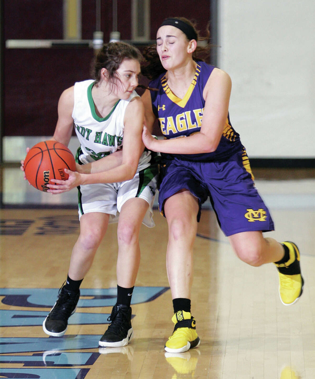 CM freshman Anna Hall is called for a foul while trying to take the ball from Carrollton’s Marley Mullink during an Eagles win Wednesday at the Jersey Tourney at Havens Gym in Jerseyville.