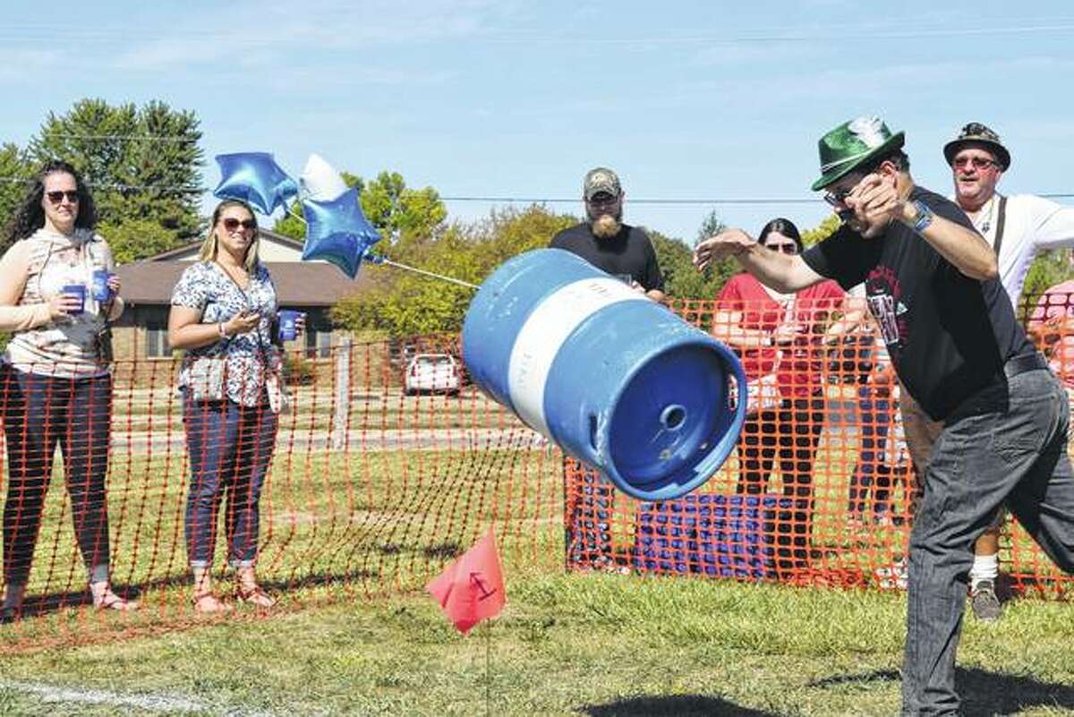 Tim Holt of Jacksonville tosses a beer keg Saturday at Rotary’s Oktoberfest.