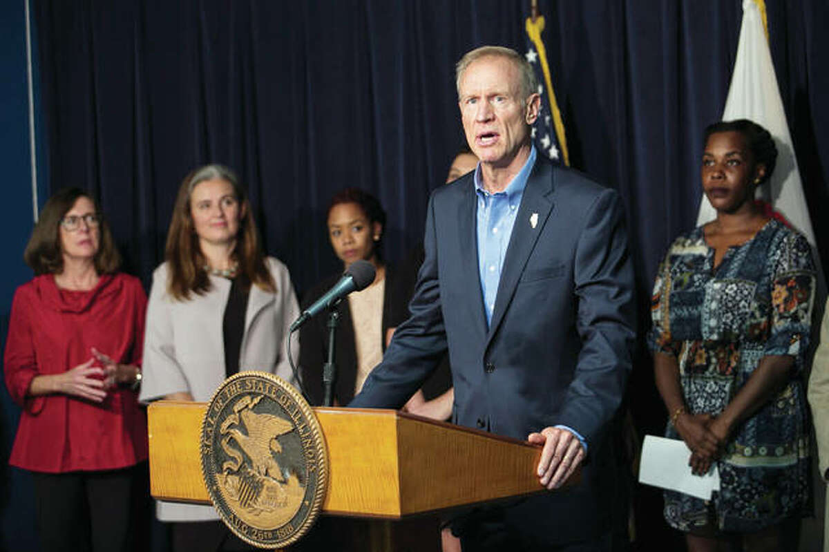 Gov. Bruce Rauner is flanked by supporters Thursday as he announces that he’ll sign legislation allowing state health insurance and Medicaid coverage for abortions. Conservatives furious about Rauner’s expansion of taxpayer-funded abortion in Illinois are threatening to put up a challenger against the first-term governor in the spring Republican primary.