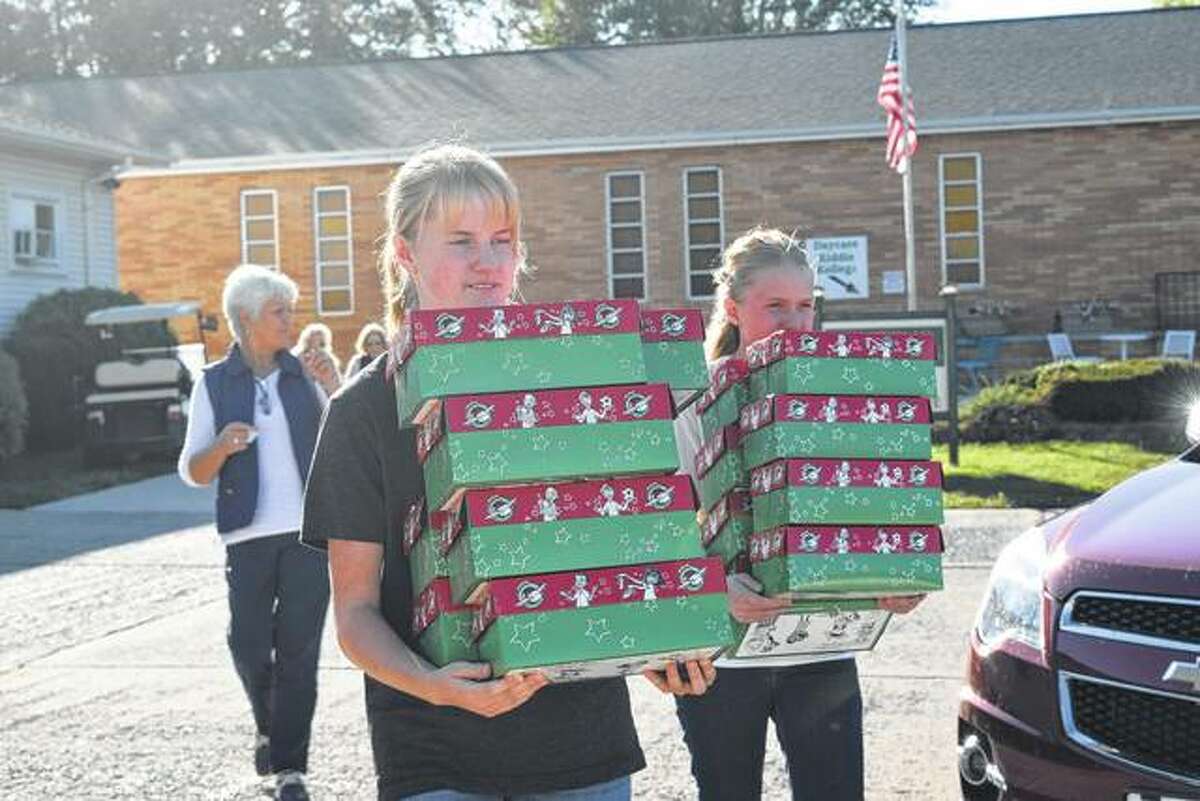 Faith and Emily Henthorn of Griggsville help carry shoeboxes Sunday afternoon during an Operation Christmas Child Shoebox Fair at Westfair Baptist Church. Operation Christmas Child is a project of the relief organization Samaritan’s Purse in which shoeboxes are filled with small toys, hygiene items and school supplies and sent to children affected by famine, poverty, war and natural disasters.