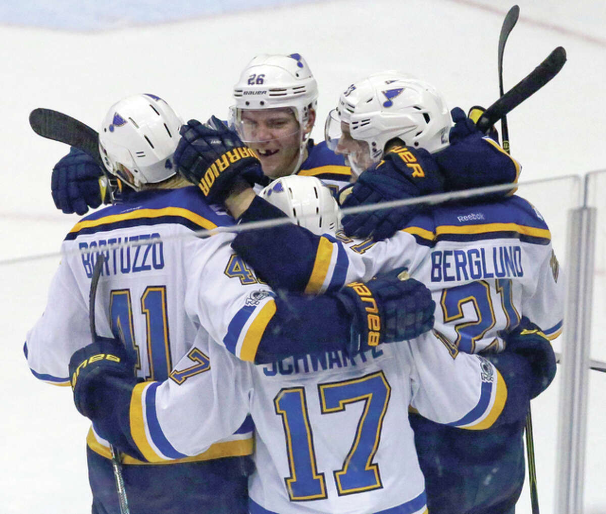 Blues players celebrate with center Patrik Berglund (right), who scored the winning goal in overtime for the 2-1 win over the Anaheim Ducks on Sunday night in Anaheim, Calif.