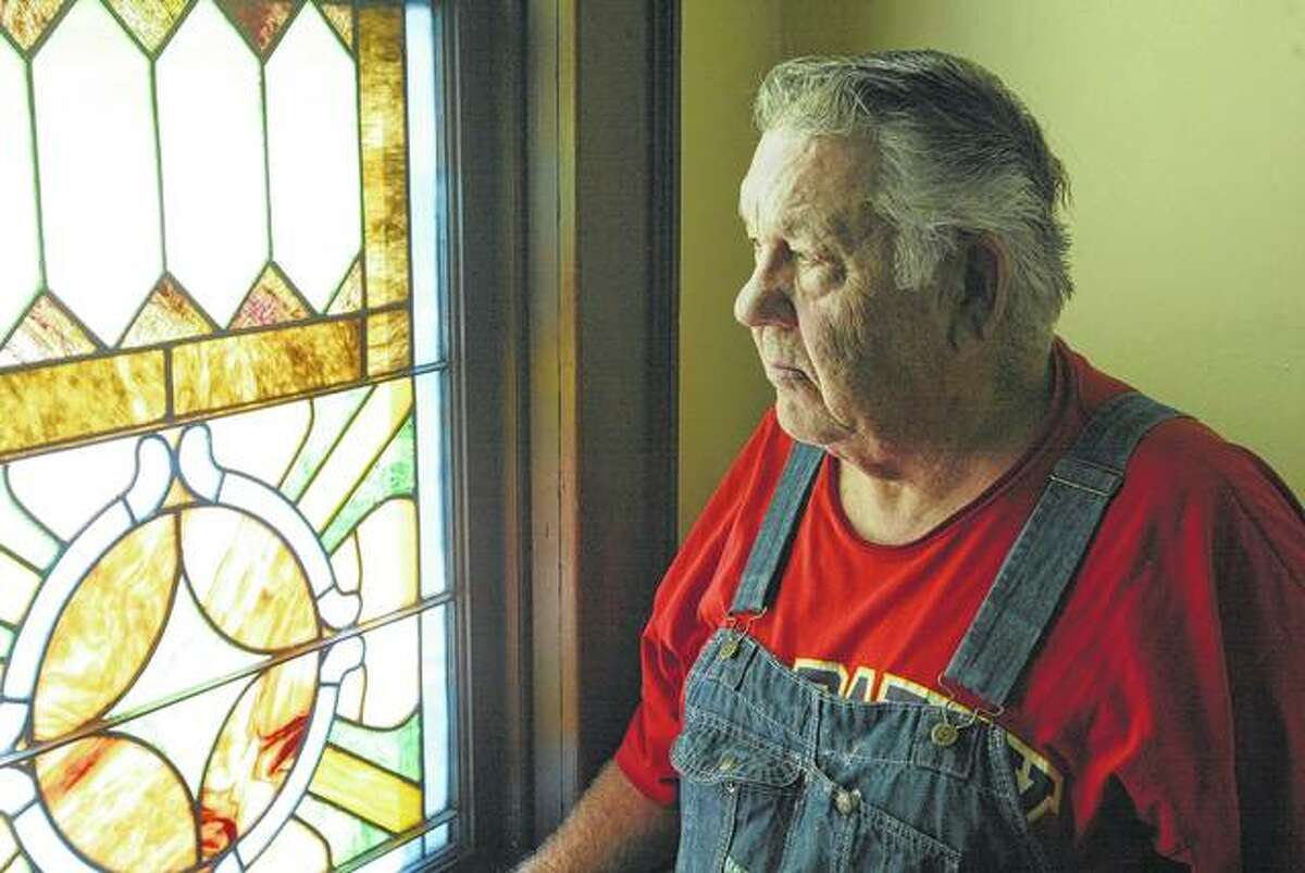 Concord Christian Church Pastor Francis Ater looks out a stained glass window at the church, which will mark its 150th anniversary Friday, Saturday and Sunday.