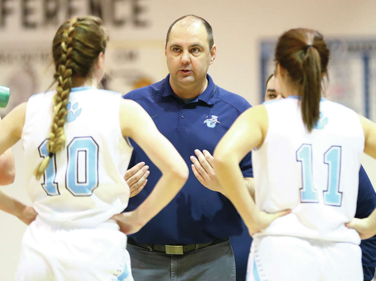 Jersey coach Kevin Strebel talks with Mackenzie Thurston (left) and Ashleigh Trochuck during Dec. 27 game in the Jersey Tourney. The Panthers beat Mascoutah on Tuesday night to clinch a winning season for the first time in five years.