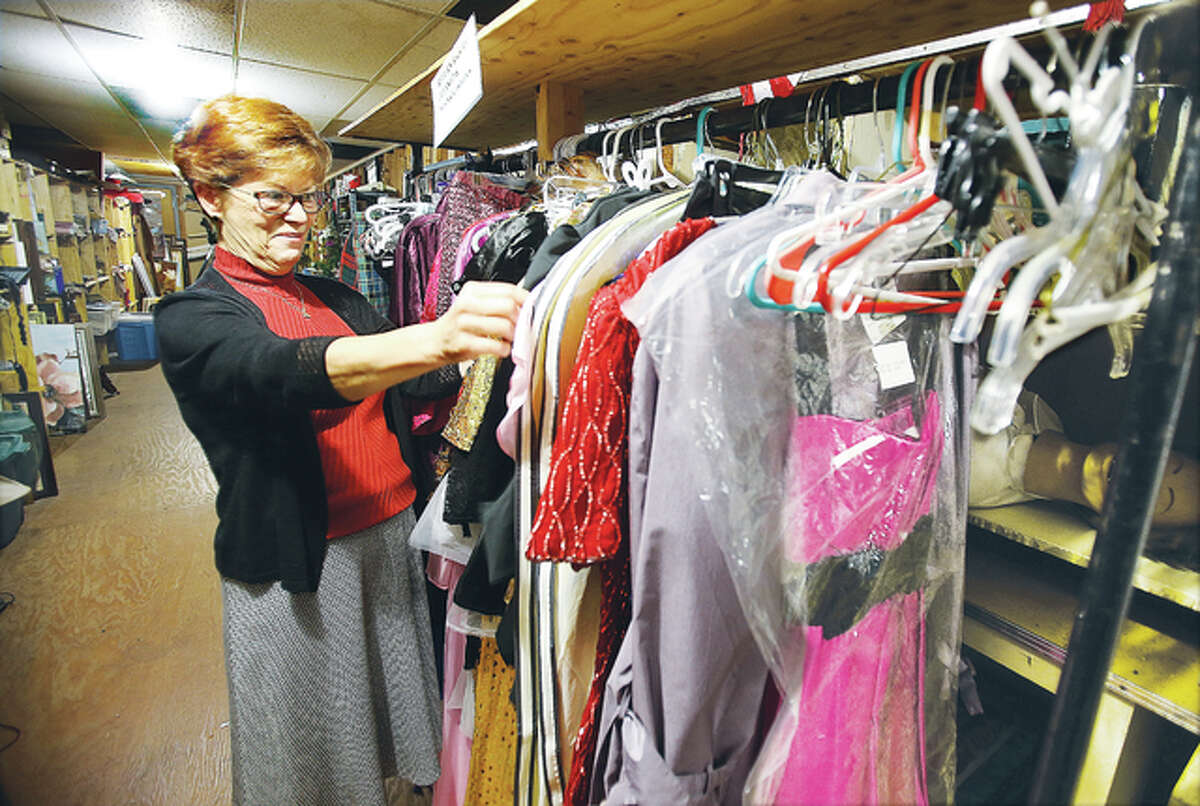 Diana Enloe, looking through some wardrobe in the extensive props department at Alton Little Theater, is retiring after nearly 40 years of directing Illinois’ longest-running community theater.