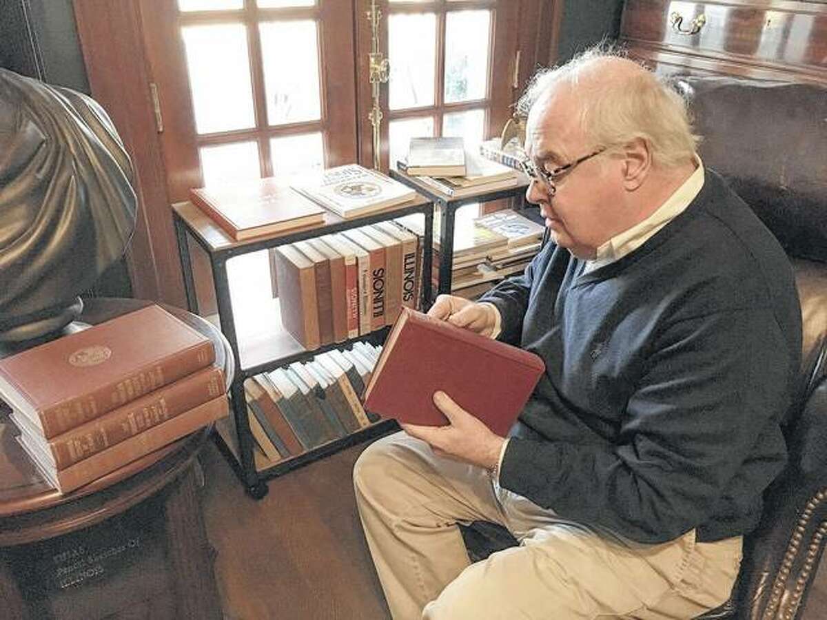 Tony Leone, a former Illinois House clerk and owner of a historic bed and breakfast near the Capitol, peruses a five-volume history of Illinois published 100 years ago for the state’s centennial. Sunday marked the state’s 199th birthday and the kickoff to a yearlong celebration leading up to the state’s bicentennial.