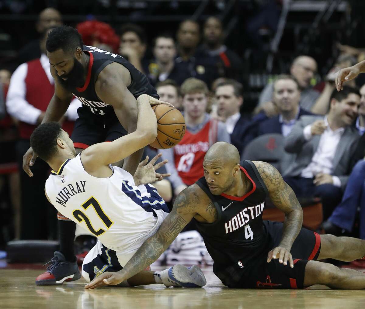 Denver Nuggets guard Jamal Murray (27) collides with Houston Rockets guard James Harden (13) and forward PJ Tucker (4) during the first half of an NBA bassketball game at Toyota Center, Friday, Feb. 9, 2018, in Houston. ( Karen Warren / Houston Chronicle )