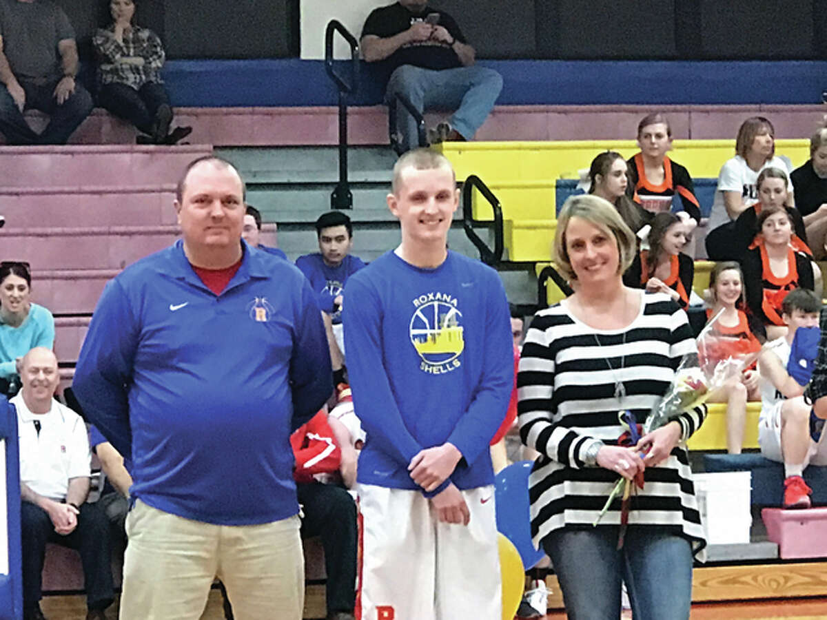 Roxana High School senior, Zach Golenor, center, is pictured with his parents, Jim and Debby Golenor, at RHS’s Senior Night last Friday. Zach broke the RHS all-time record for being the second-highest scoring student in his four-year athletic career to make 1,418 points.