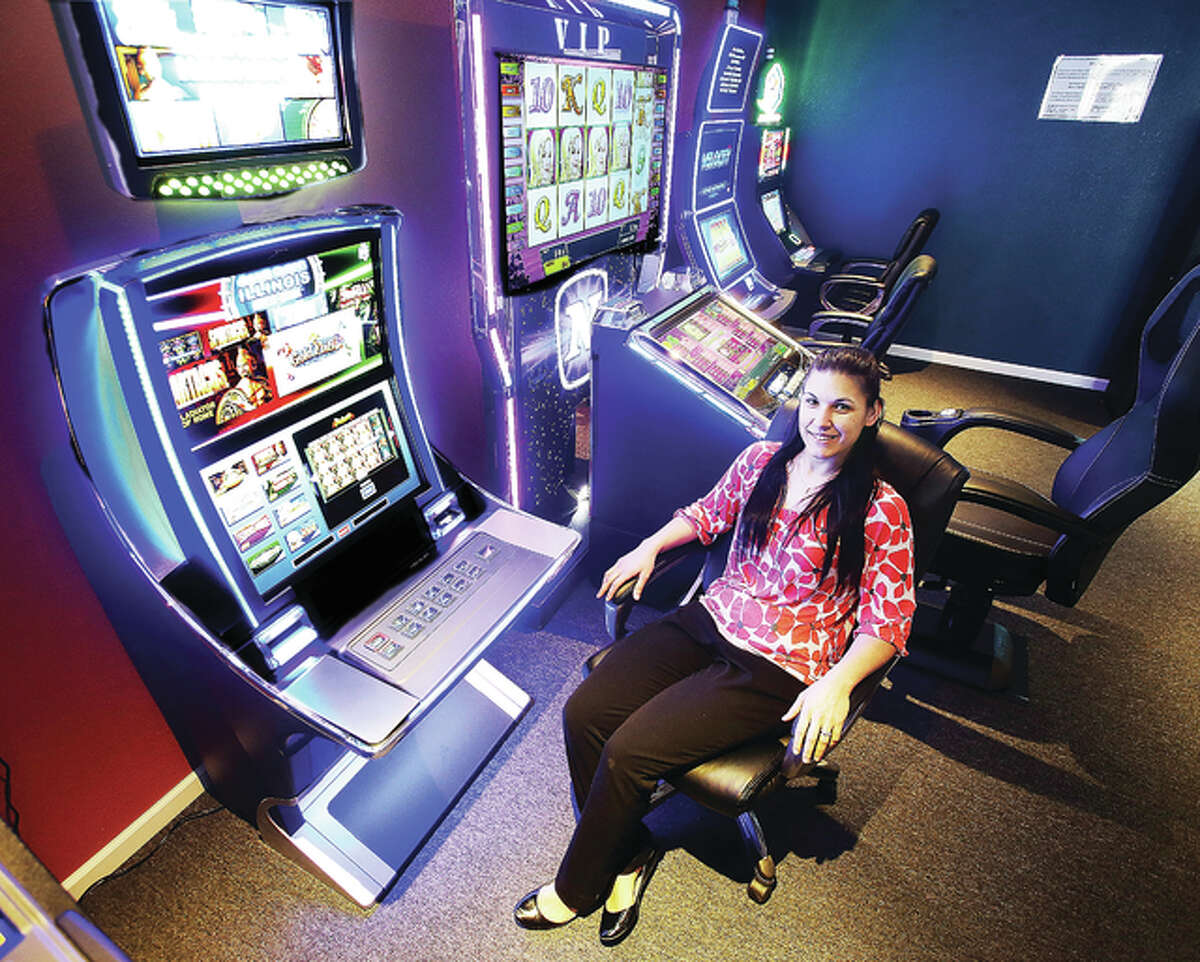 Rachael Coleman, owner of Lucky Jack’s, 100 Kingshighway in East Alton, sits in the gaming room of the recently opened establishment. The new bar aims to cater to a relaxed crowd while offering a casino-like experience.