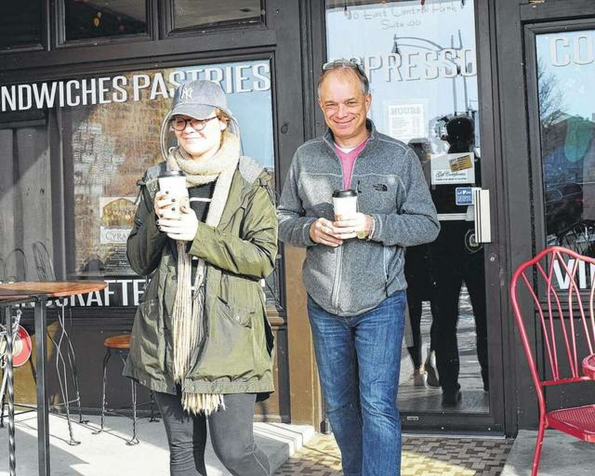 Grayce and Steven Lillpop leave The Soap Co. Coffee House on Tuesday with hot drinks in hand.