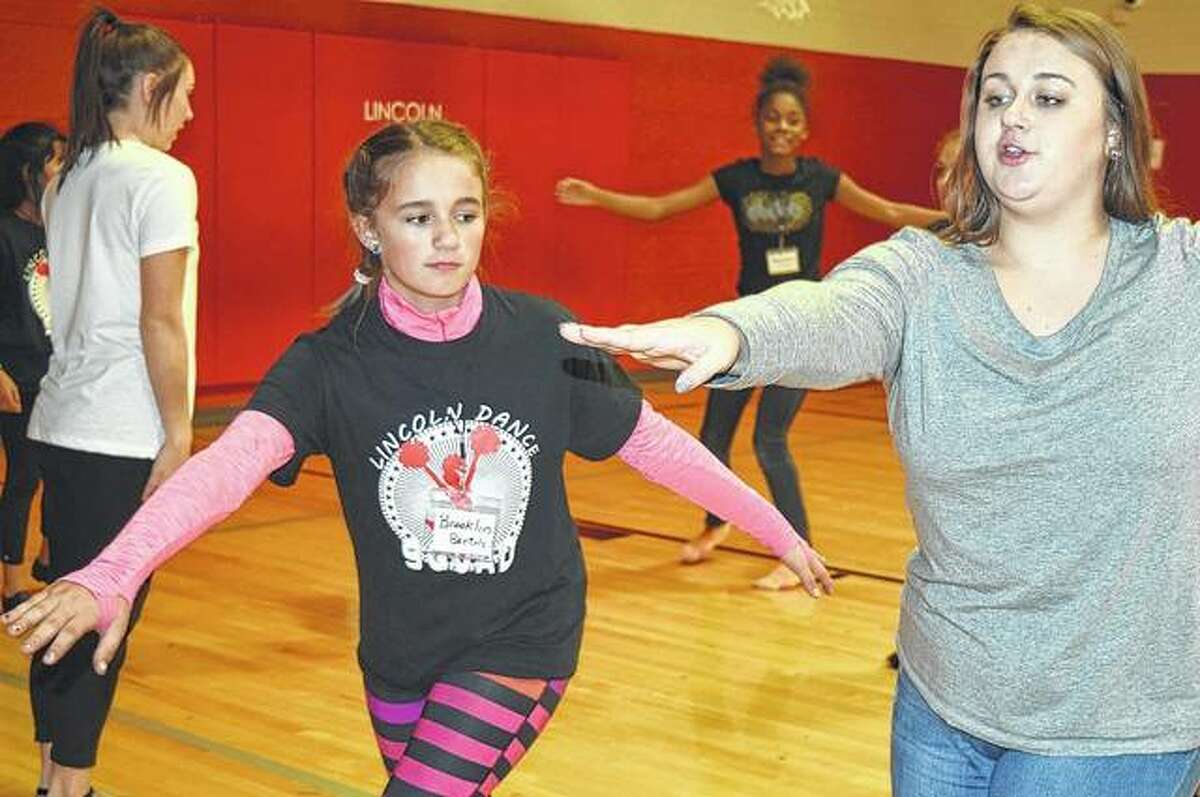 Camri Anderson helps coach Lincoln Elementary School dance team members during a November workshop with Illinois College dance team members. Anderson was an assistant coach for the Lincoln team.