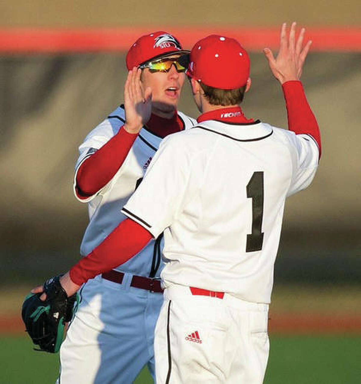 SIUE’s Alec Skender (1) and a teammate celebrate during the Cougars’ series-opening victory over Northern Illinois on Friday at Roy E. Lee Field in Edwardsville. SIUE completed the four-game sweep of Northern Illinois on Sunday.