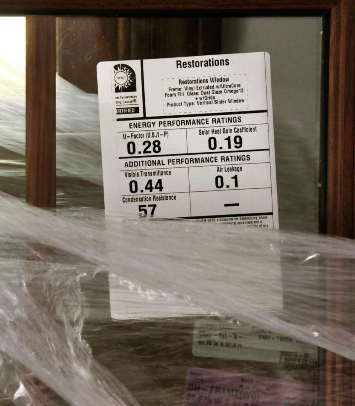 A LABEL gives the energy efficiency on windows being installed by R.M. Pena Inc. (John Carl D?Annibale / Times Union)