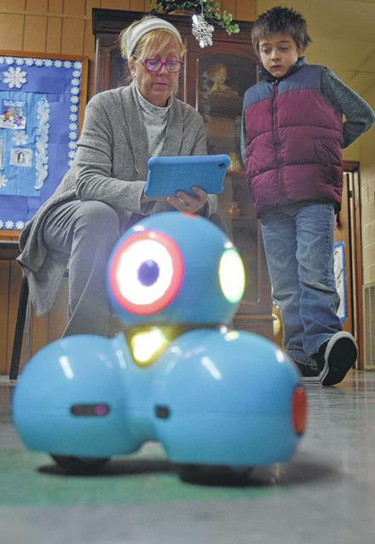 Robin Walker, marketing and events librarian at Brown County Public Library, shows Roan VanCleave, 9, of Mount Sterling the basics of the library’s new robot.