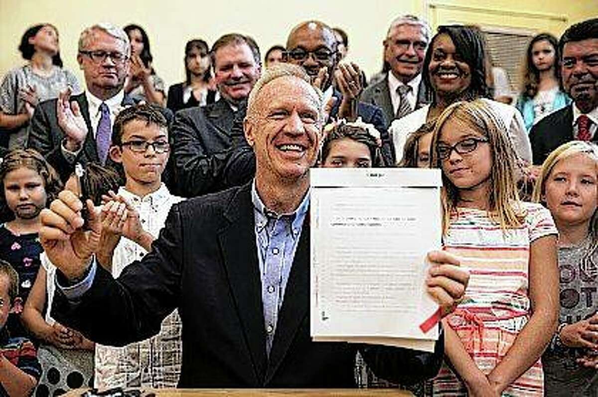Gov. Bruce Rauner signs education funding reform last year. Campaign finance disclosures filed this week show $9 of every $10 in this year's governor's race was spent by just two candidates — Rauner and the leading Democratic challenger, businessman J.B. Pritzker. Ashlee Rezin | Sun Times (AP)