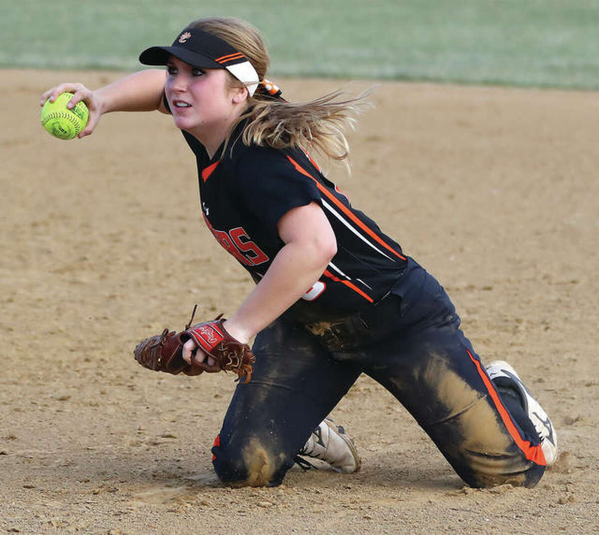 Edwardsville second baseman Emma Lewis gathers herself for a throw to first base for an out after making a diving stop to rob Gillespie’s Rylee Jarman of a hit and the Miners of two runs for the final out in the fourth inning Monday in Gillespie.