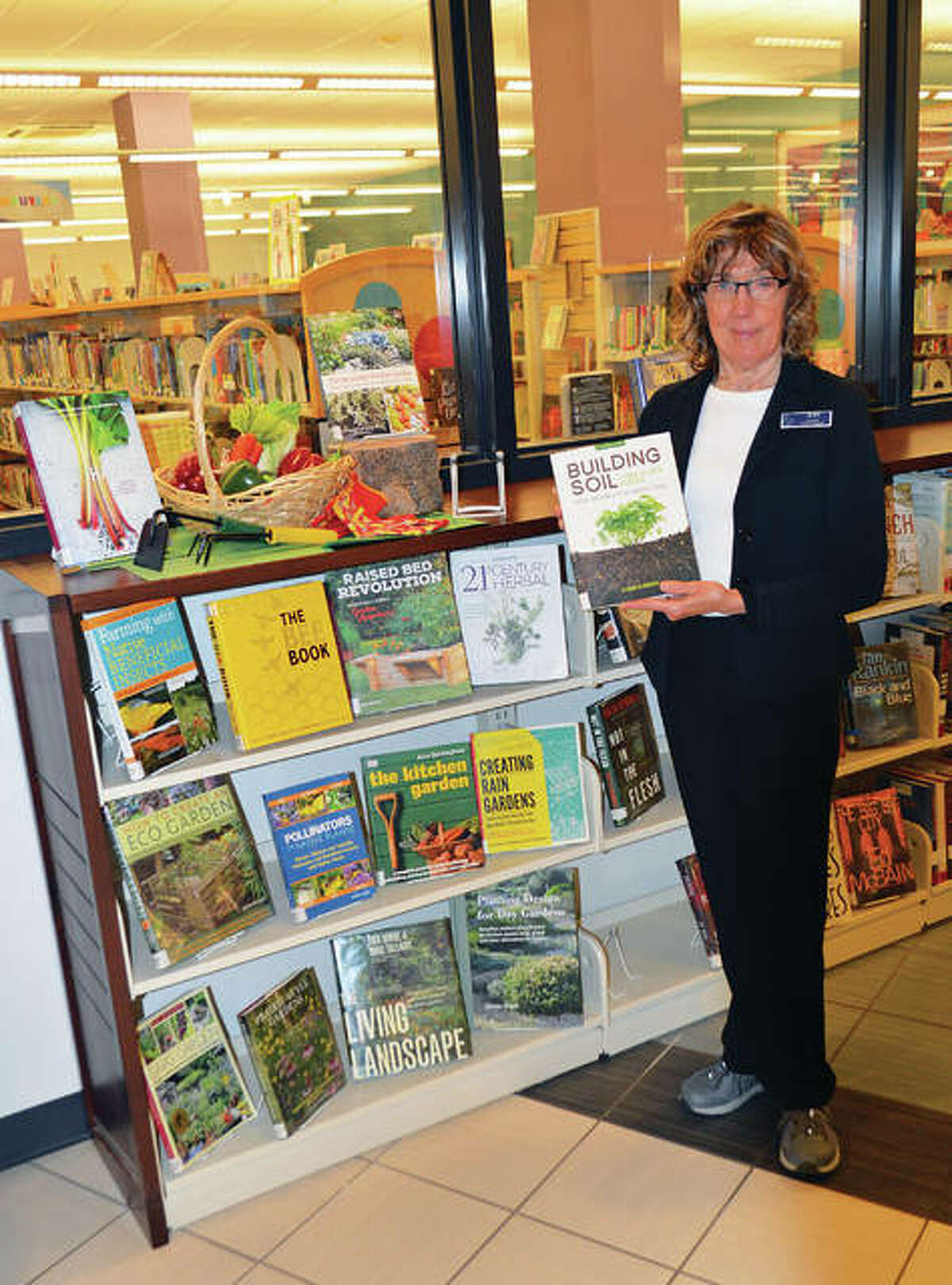 Book displays with a range of garden topics are arranged by Jean Shimunek to encourage program attendees to do further research on their own.