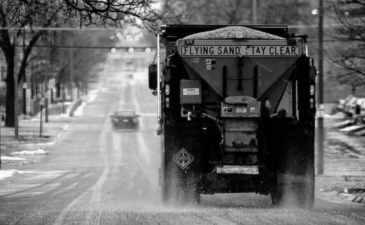 A truck spreads salt after a winter storm. Scientists are starting to raise concerns about road salt's impact on the environment, especially drinking water, because lakes and streams near roads are showing elevated levels of sodium and chloride. Eric Gregory | The Journal Star (AP)