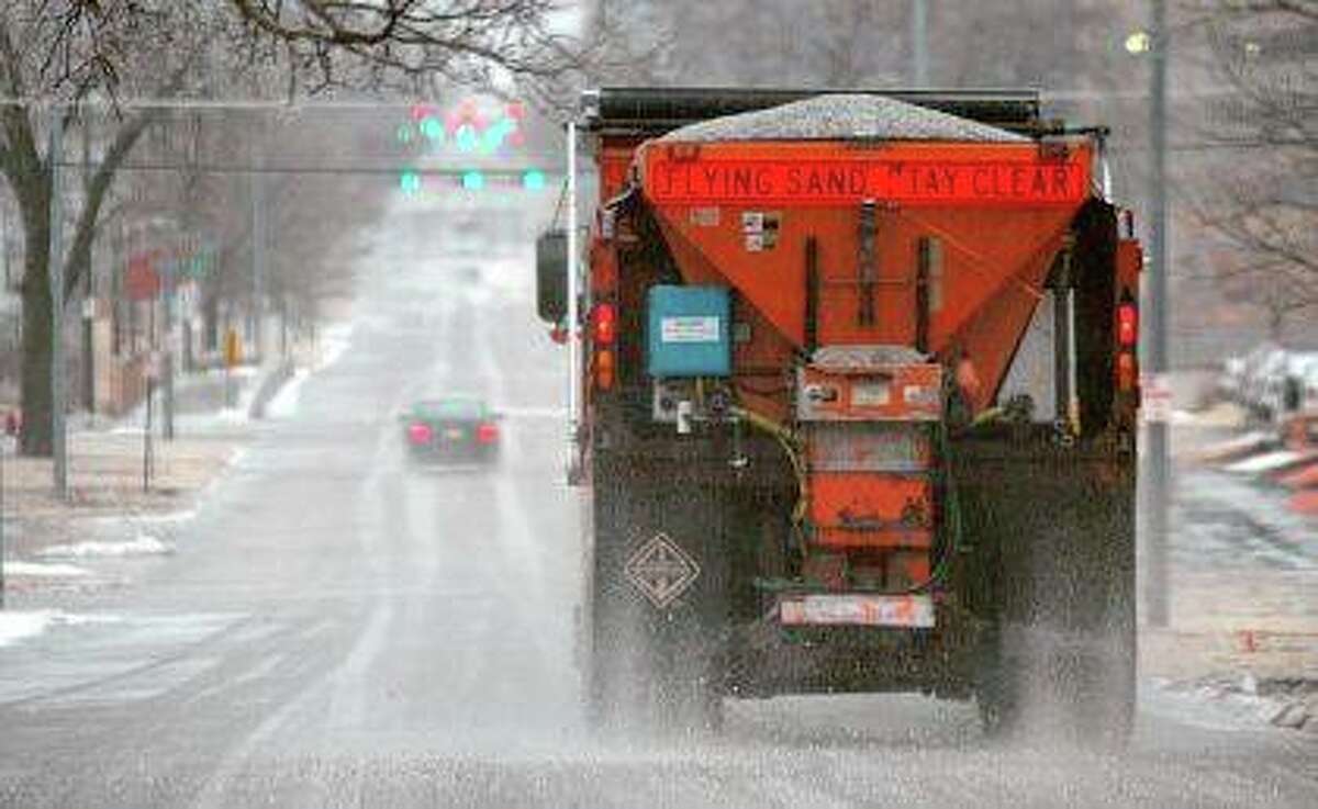 A truck spreads salt after a winter storm. Scientists are starting to raise concerns about road salt's impact on the environment, especially drinking water, because lakes and streams near roads are showing elevated levels of sodium and chloride. Eric Gregory | The Journal Star (AP)