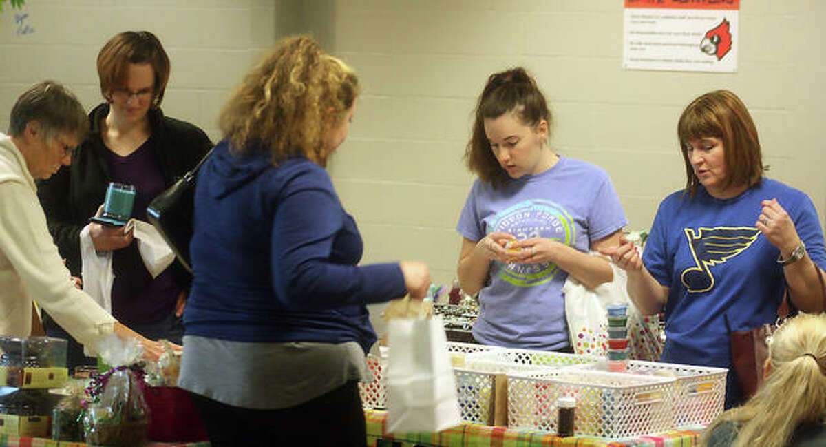 Attendees of Olde Alton Arts and Crafts Fair peruse one of the 100 booths that packed the hallways of Alton High School Saturday. The annual event, including a pancake breakfast, raised approximately $2,500 for the Alton Band and Orchestra Builders program.