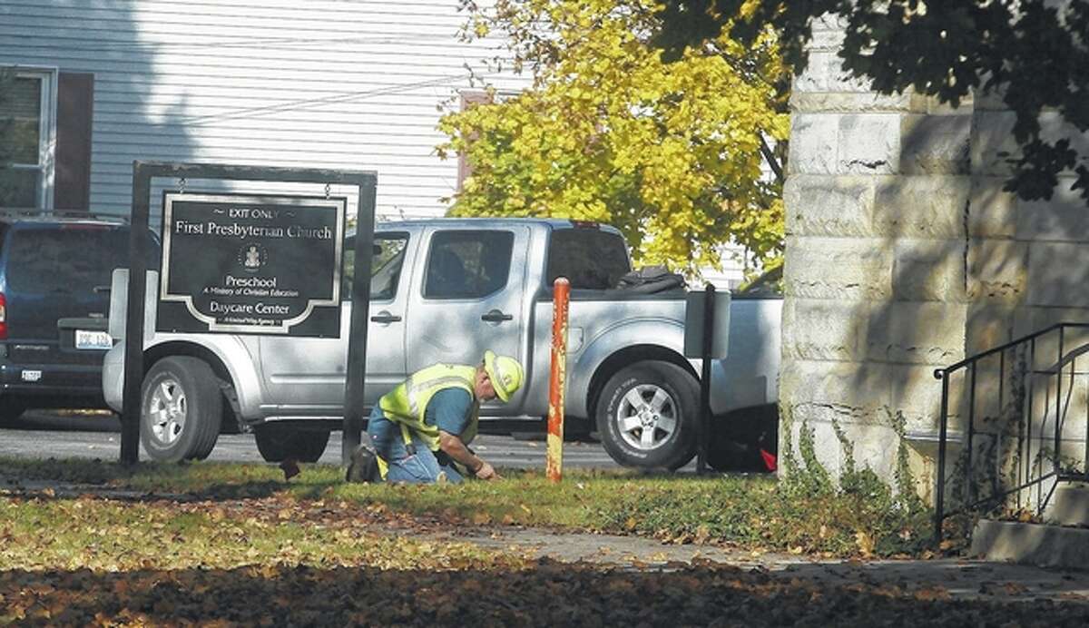 An Ameren worker tries to shut off a natural gas line at First Presbyterian Church in Jacksonville after the pipe was hit Wednesday, causing a brief gas leak.