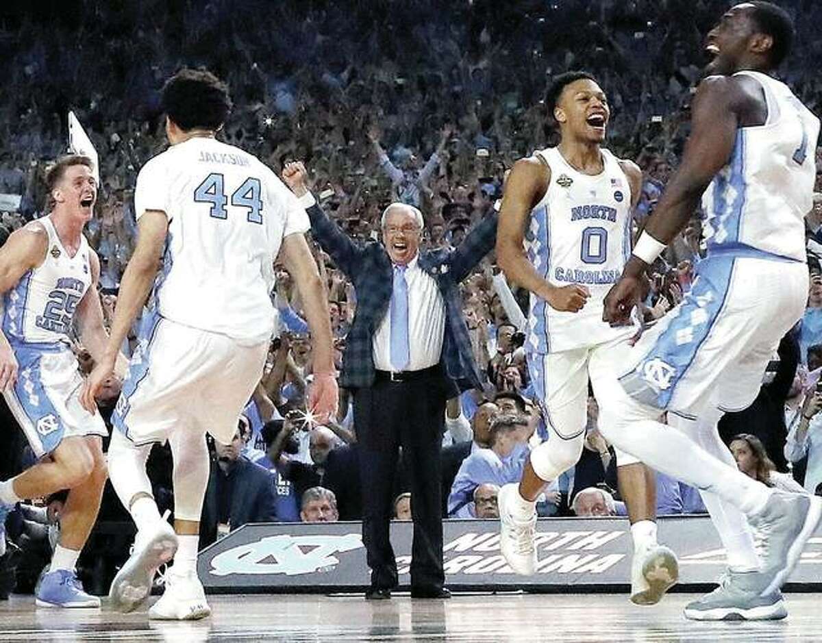 North Carolina head coach Roy Williams and players celebrate their 71-65 win over Gonzaga in Monday night’s NCAA championship game in Glendale, Ariz.