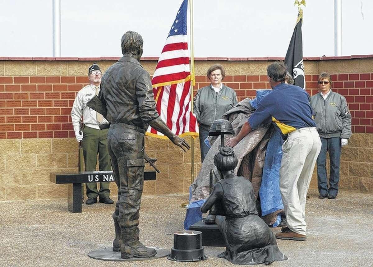 About 500 people watched the unveiling of these bronze figures at the dedication of the Beardstown Veterans Memorial on Veterans Day. The memorial, which is in Roy Roberts Park, was designed to honor all veterans, not just those from Beardstown, according to veterans memorial co-chairman Richard Zillion.