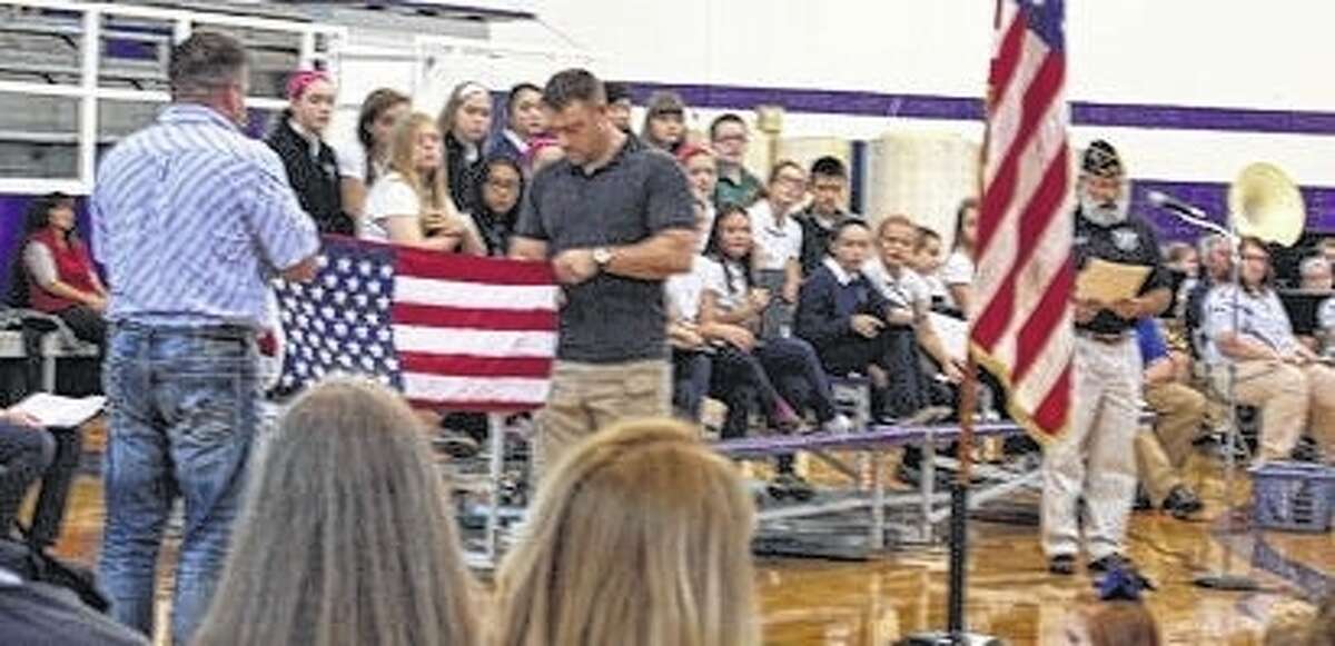 Our Saviour School and Routt Catholic High School students participated in a Veterans Day program Wednesday. Colors were posted by Jayden Ware and Coy Beddingfied. Army veteran John Elliott spoke to students about his military background. Routt grads Jacob English and Mike Morrow, along with Bill Morrow, explained the meaning of each fold of the flag. The junior-senior high school band played “The Star-spangled Banner” and the military medley. The OSS choir sang “My America” and “Sing A Song of Peace.” Routt students Lilly Schwiderski and Alaina Colclasure read the names of more than 50 Routt graduates who have served or are serving in the military.