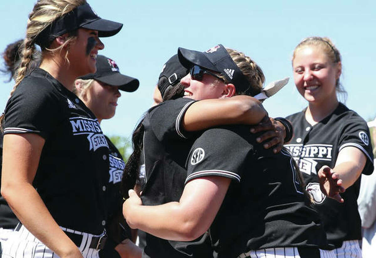 Mississippi State senior Alexis Silkwood (center, right) is embraced by a teammate after Silkwood posted her school-record 56th win in the Bulldogs SEC softball victory Saturday in Starkville, Miss. Silkwood, from East Alton, is also the Illinois high school state record-holder in wins with 124 from four seasons at Marquette Catholic.