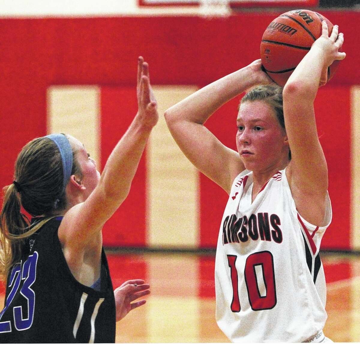 Jacksonville’s Daisy Wood looks for an open teammate during a basketball game against Quincy Tuesday in Jacksonville.