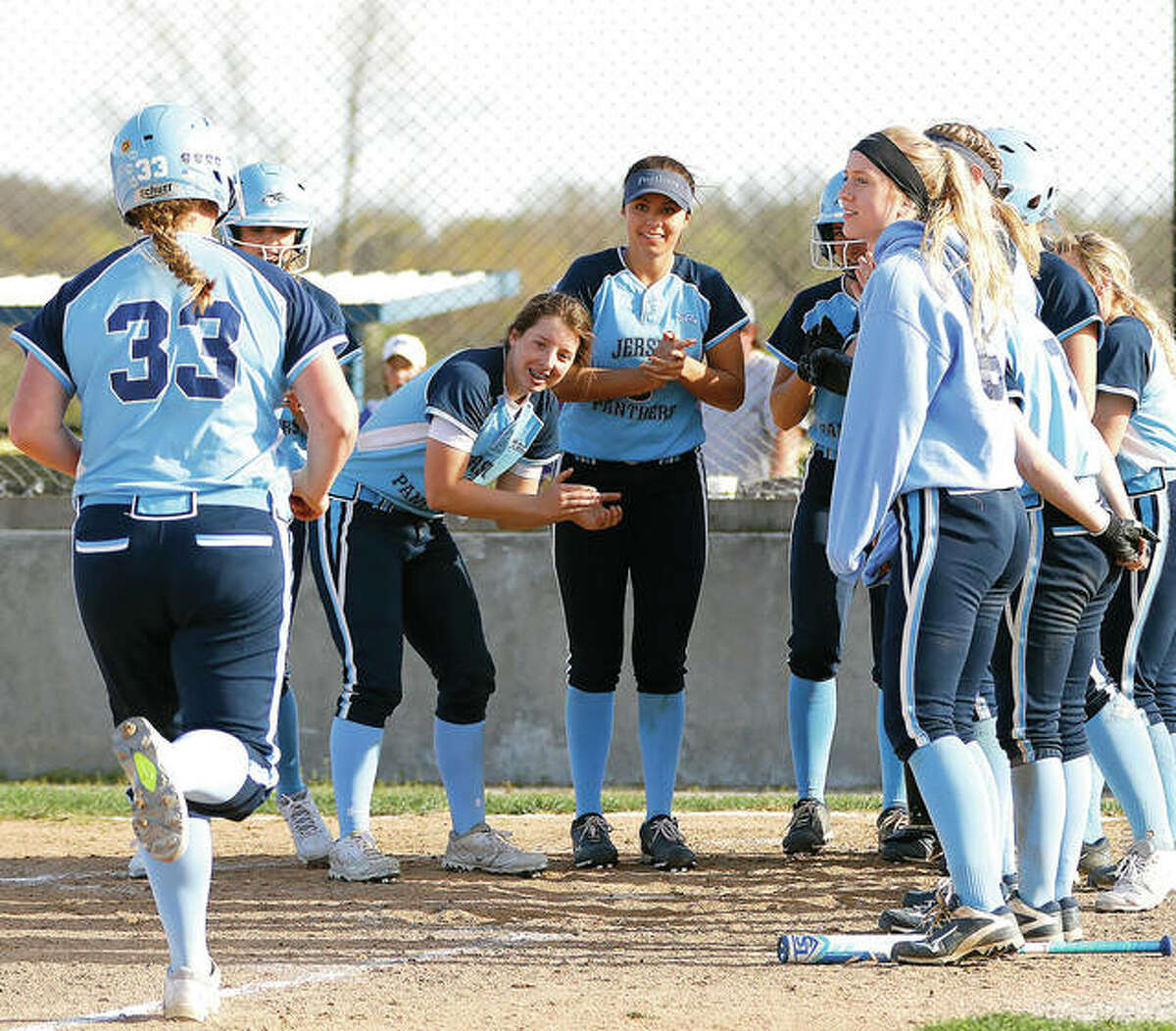 Jersey’s Bethany Muenstermann (33) is greeted by teammates as she heads to home plate after hitting a three-run home run Wednesday in the Panthers’ Mississippi Valley Conference opener against Civic Memorial at the Bethalto Sports Complex. Muenstermann also had a double and went 3-for-6 with five RBIs for the Panthers, who ran their record to 10-0 overall and 1-0 in the MVC with a resounding 22-10 victory. Also for CM, Ashton Tewell went 5-for-5 with a double and three RBIs, Caitlyn Connell was 5-for-5 with an RBI, Chelsea Maag was 4-for-5 with a homer, a double and three RBIs, Peyton Tisdale was 3-for-4 with four RBI and Libby Munsterman was 3-for-5 with a double and two RBIs. Visit thetelegraph.com for further coverage.