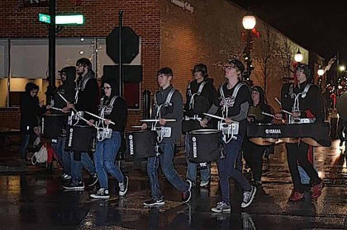 Members of the Jacksonville High School Drumline march in the Christmas Parade Friday.
