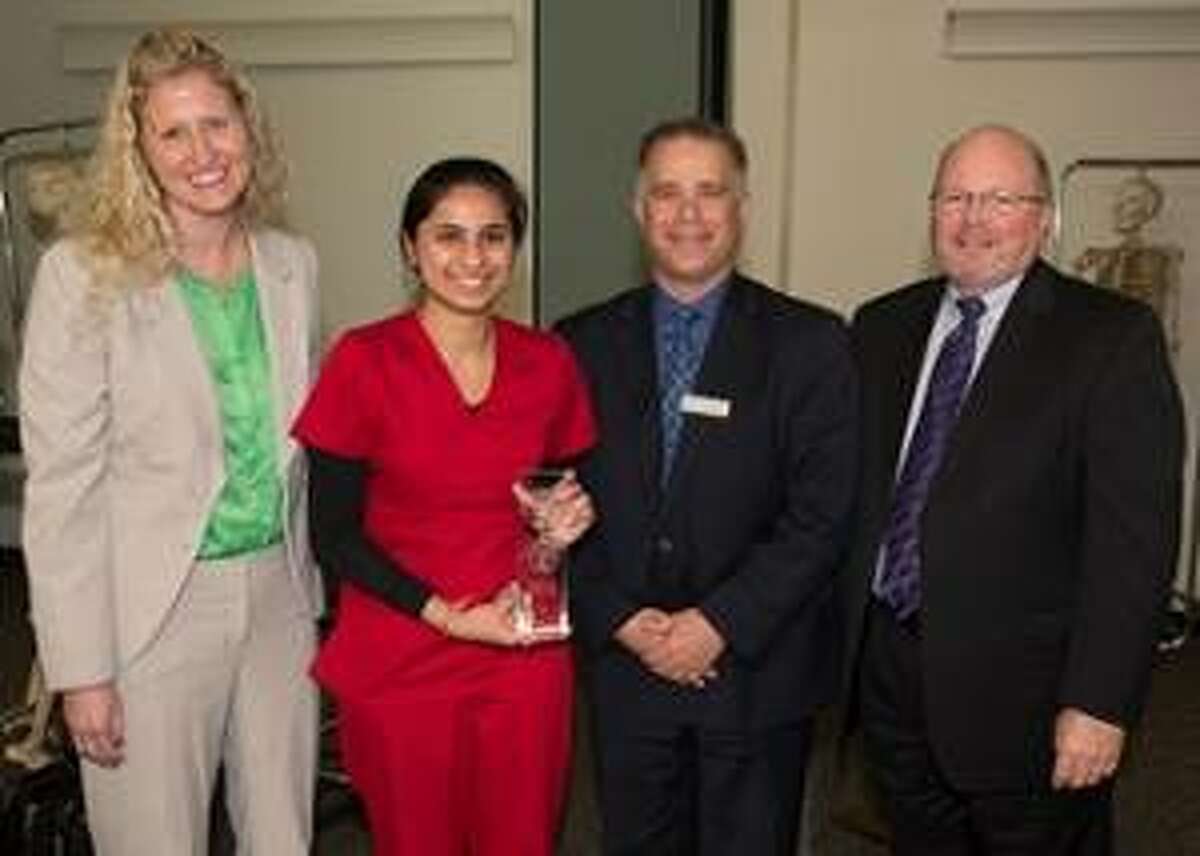 Southern Illinois University School of Dental Medicine Year Two Vidhi Pandya earned first place during the Student Table Clinic Exhibition. She holds her award, and stands with representatives from Dentsply Sirona Amy Schneider and Joel Pluymert, and SIU School of Dental Medicine Dean Dr. Bruce Rotter (far right).