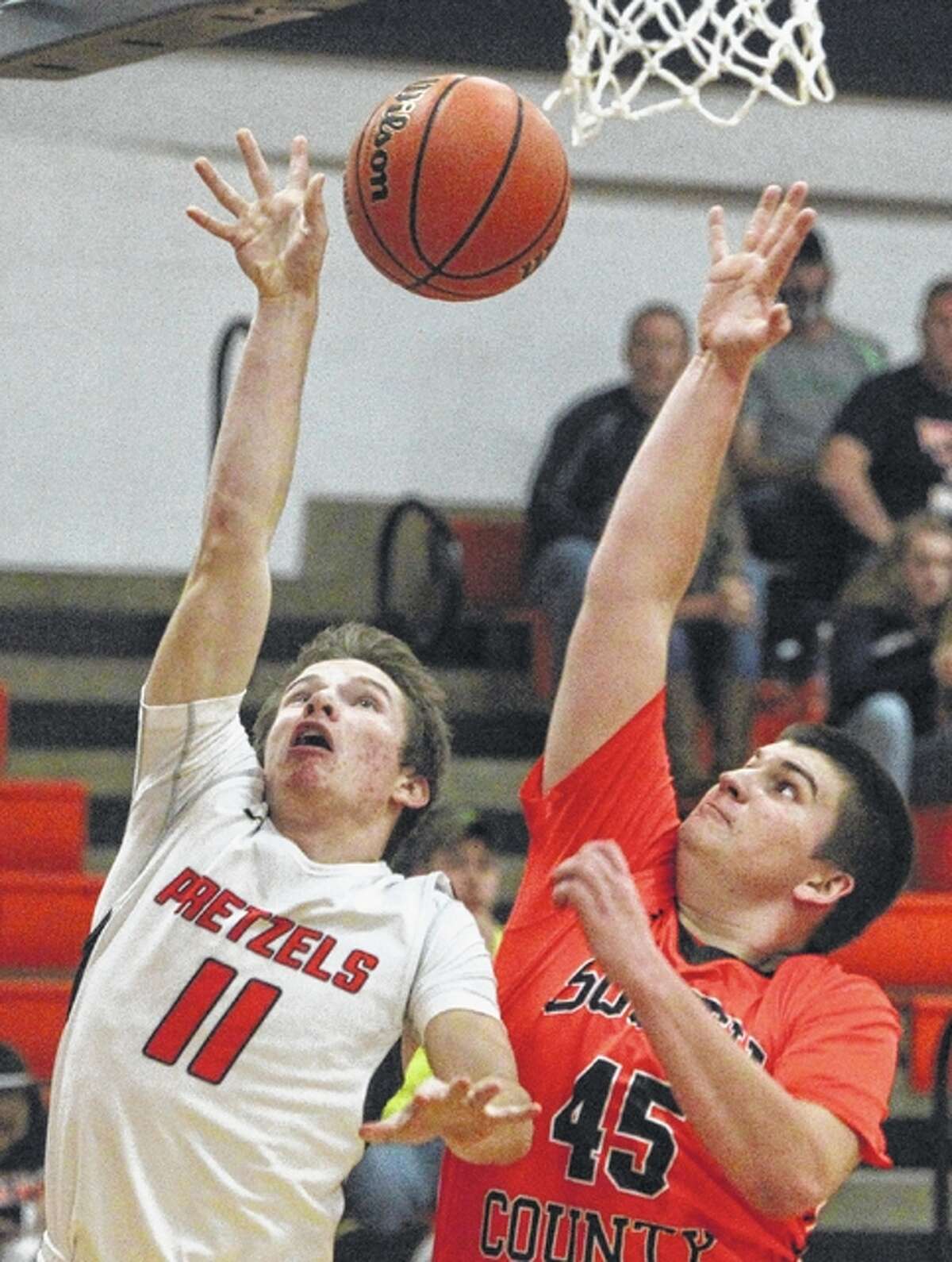 New Berlin’s Josh Fuchs puts up a shot as South County’s Lewis Wallbaum defends during a basketball game Friday at the Gene Bergschneider Turkey Tournament in New Berlin.