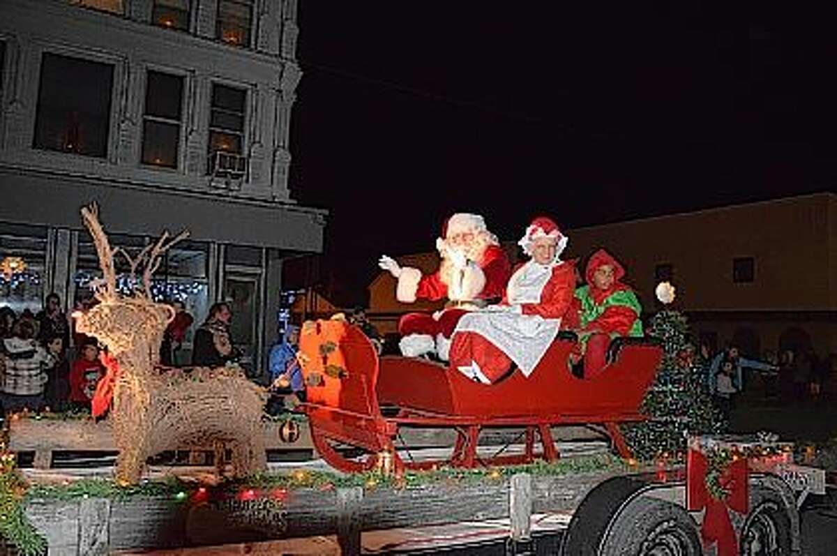 Santa and Mrs. Claus arrive in Virginia on their reindeer drawn sleigh accompanied by two of their elves Friday night during the Christmas in Virginia parade.