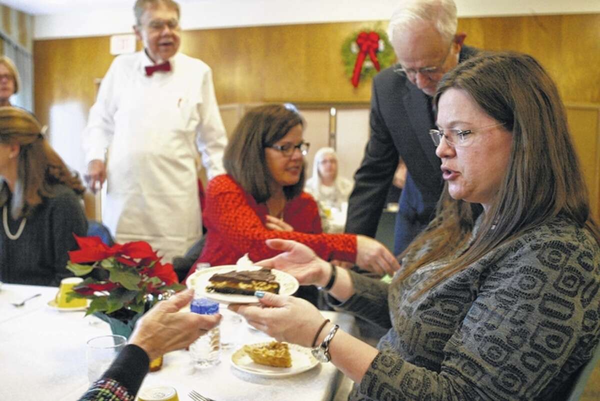 Elizabeth Becker of Jacksonville passes a piece of cake at the Trinity Episcopal Church holiday bake shoppe, bazaar and luncheon. The bazaar has happened annually for over 50 years and is the church’s biggest fundraiser for outreach programs.